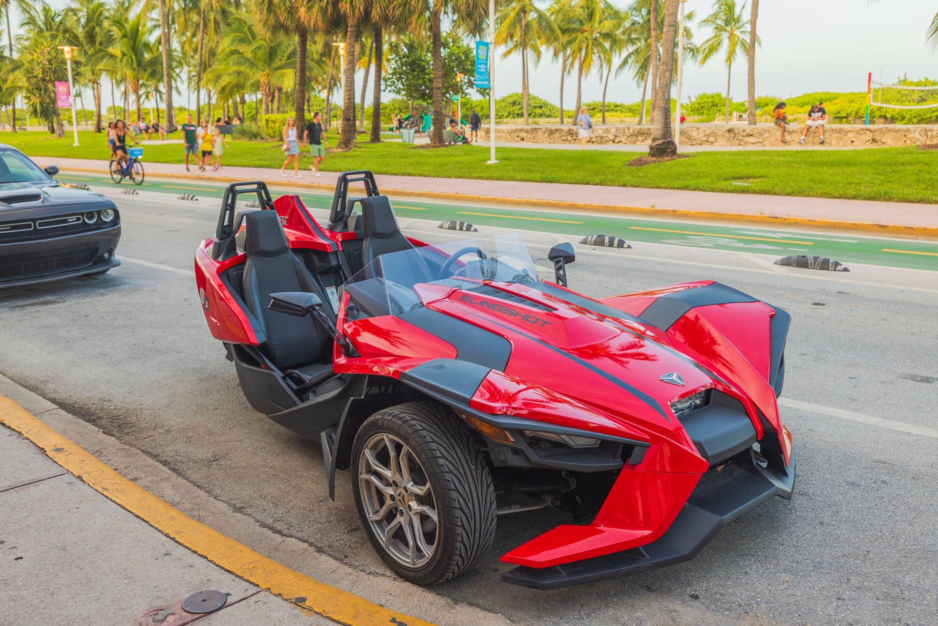 View of front red Polaris Slingshot parked on Ocean Drive in Miami Beach.